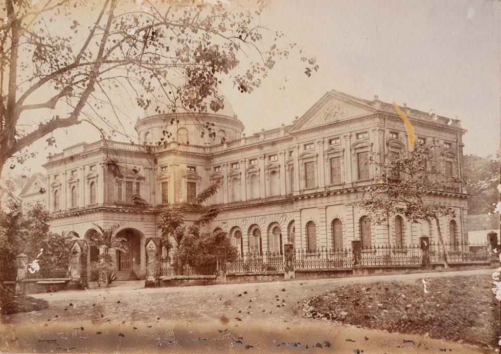 A faded black and white photograph of the Raffles Library and Museum building at Stamford Road. The photograph was taken between 1895 and 1901 by Karl Richard Hanitsch who oversaw the Museum at the time.