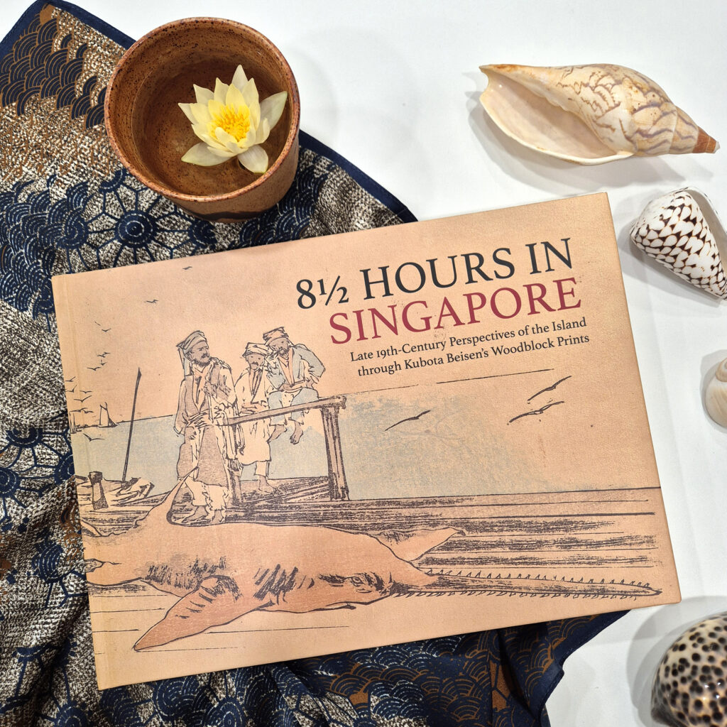 Photograph of ‘8½ Hours in Singapore: Late 19th-Century Perspectives of the Island through Kubota Beisen’s Woodblock Prints’ against a backdrop of seashells.